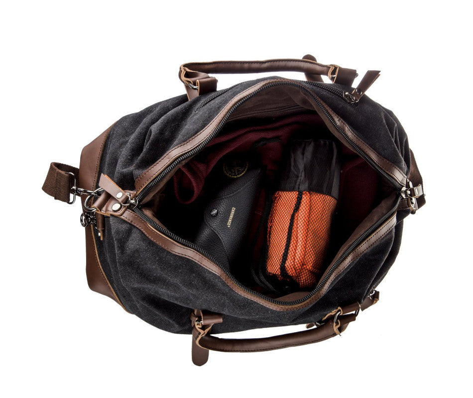 A black and brown Parvus 42L Duffel Bag, perfect as a weekend bag, travel bag, and carry-on luggage. This stylish and durable bag features seven pockets and genuine leather accents, making it ideal for short getaways, longer trips, and daily use.