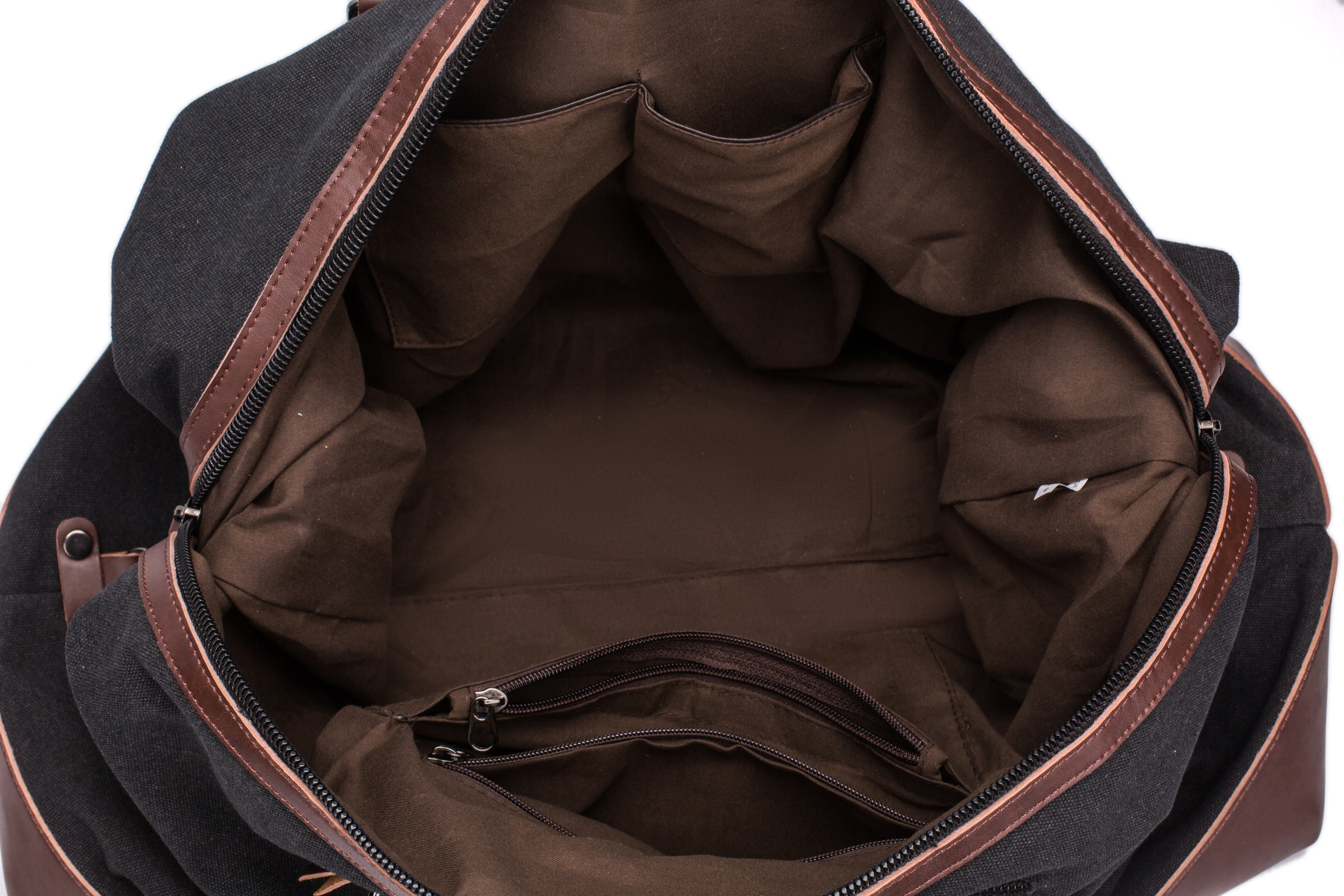 A black and brown Parvus 42L Duffel Bag, perfect as a weekend bag, travel bag, and carry-on luggage. This stylish and durable bag features seven pockets and genuine leather accents, making it ideal for short getaways, longer trips, and daily use.